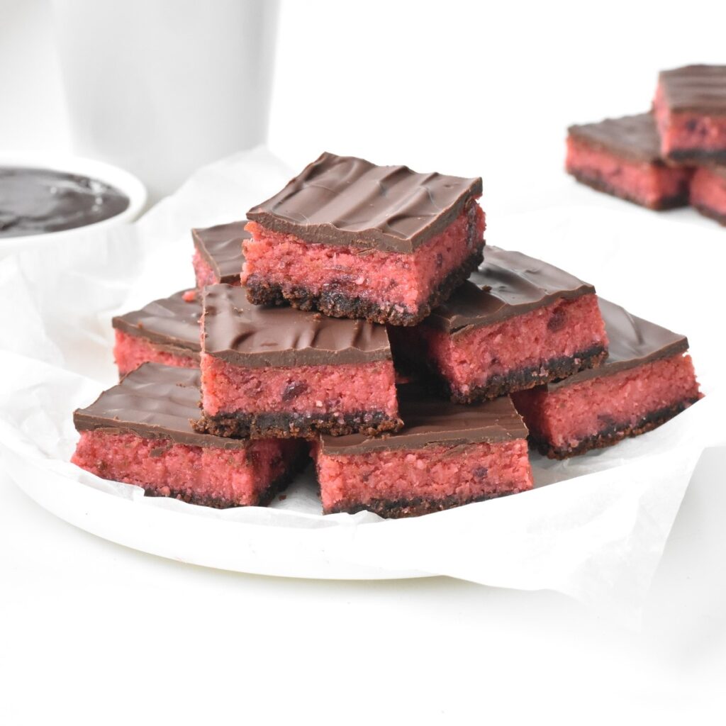 Cherry Ripe Slice squares stacked on a plate.