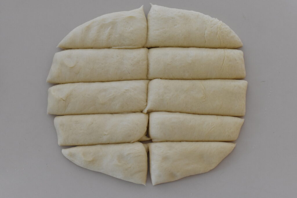 Dough in shape of rectangle divided into 10 pieces.