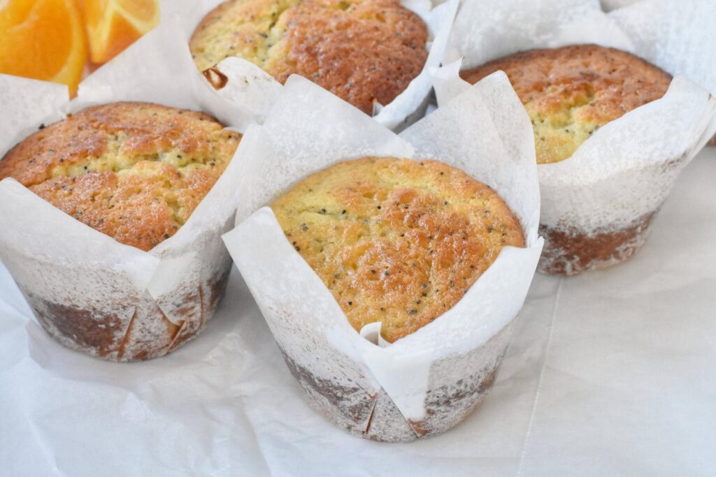 Baked Orange Poppyseed Muffins in paper cases.
