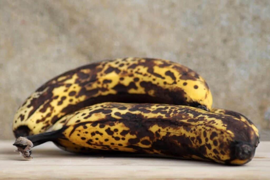 Ripe bananas on wooden board.