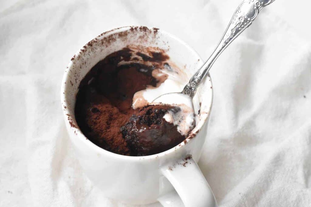 Self-Saucing Chocolate Pudding in A Mug after cooking with ice cream.