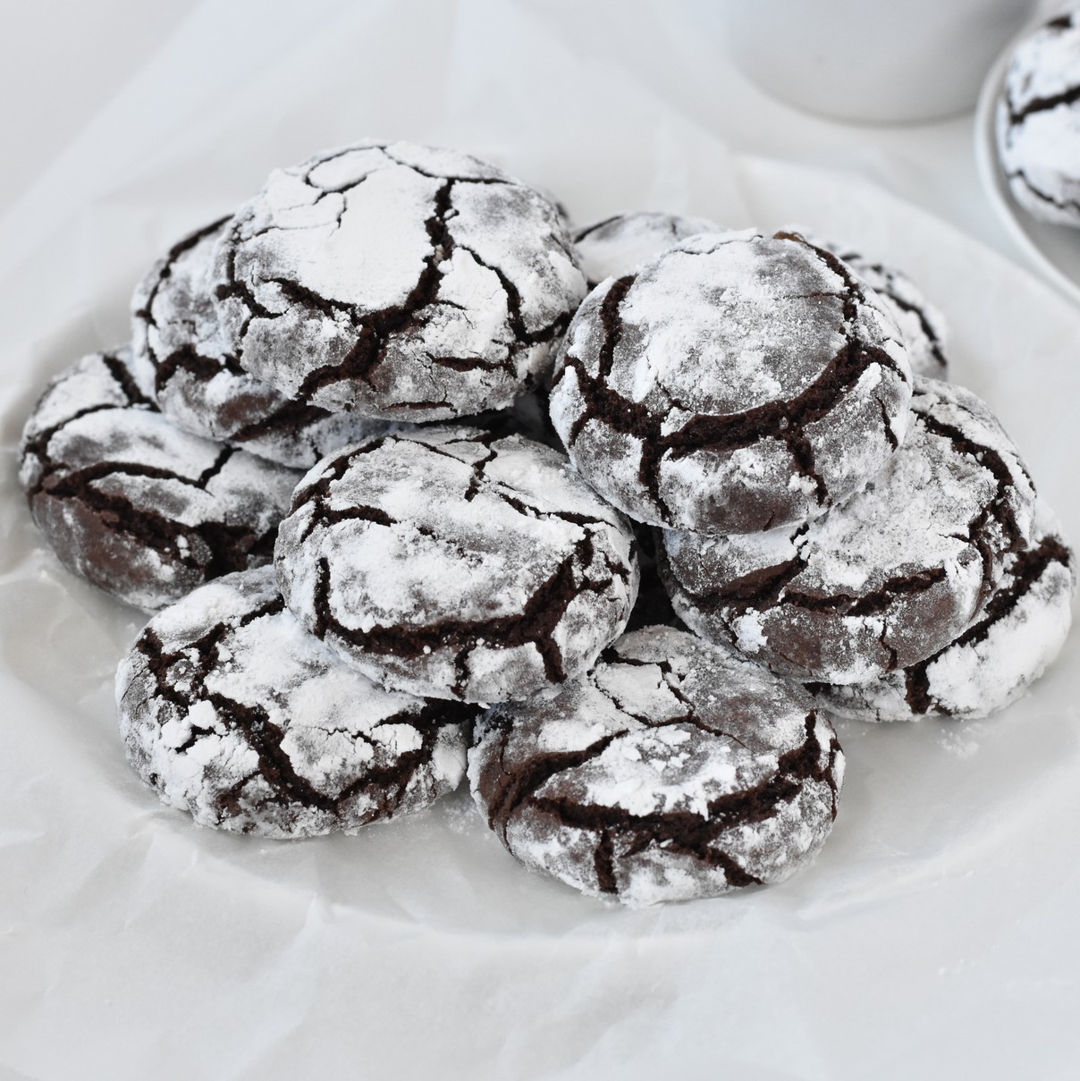 Chocolate crinkle cookies stacked in a pile.