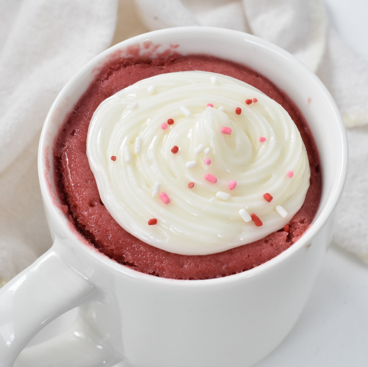 Red Velvet Mug cake with Frosting and Sprinkles