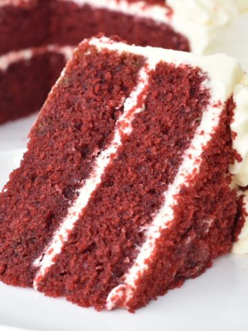 Slice of red velvet cake on a plate.
