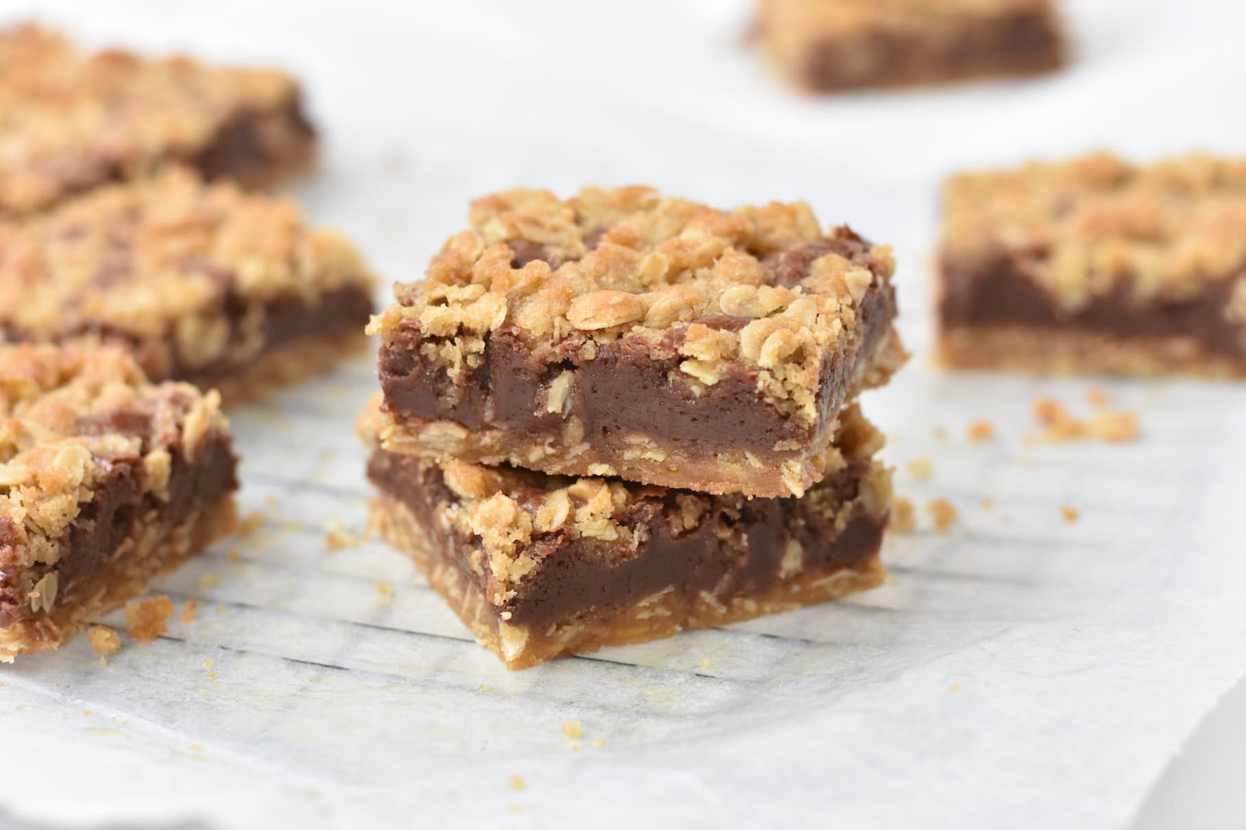 Stacked and sliced oat fudge bars on tray.