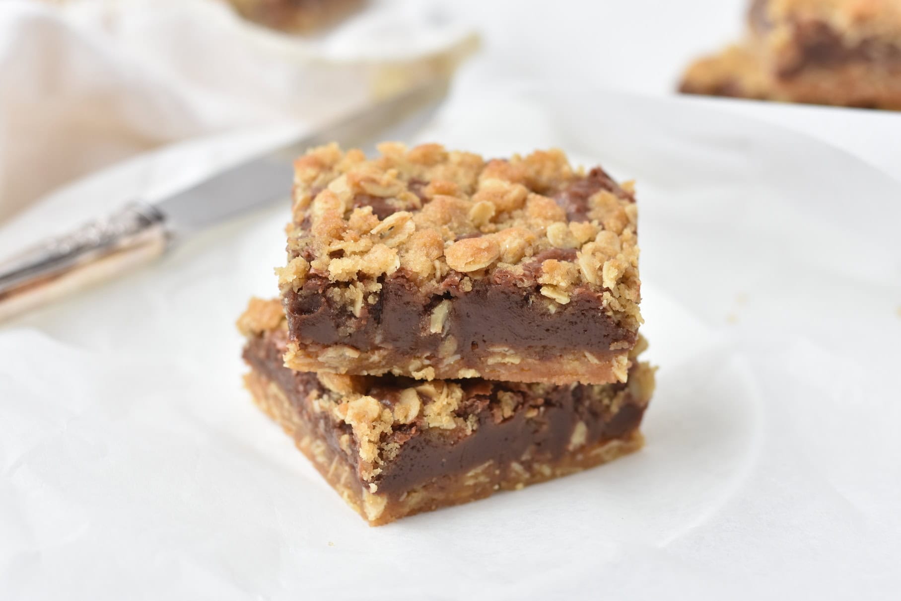 Sliced oat bars stacked on plate.