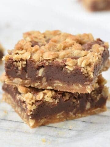 Stacked and sliced oat fudge bars on tray.