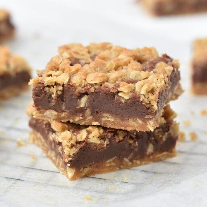 Stacked and sliced oat fudge bars on tray.
