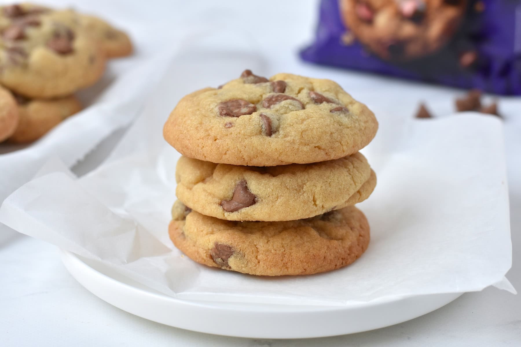 Stack of three cookies on a plate.