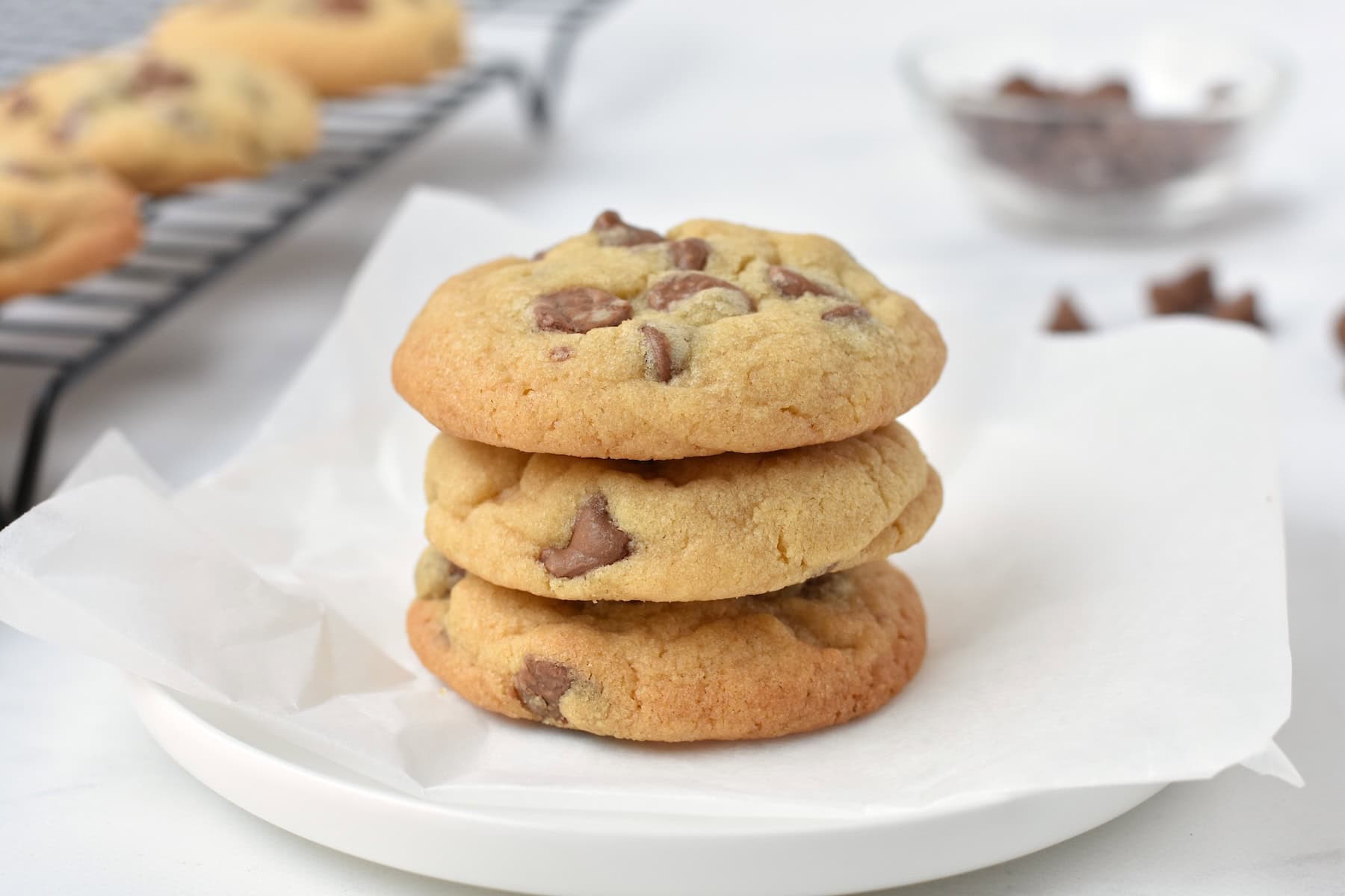 Stack of three cookies on a plate.