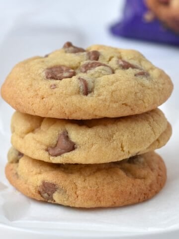 Stack of three cookies on a plate.