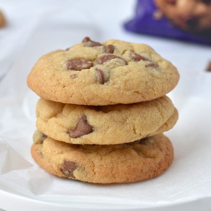 Stack of three cookies on a plate.