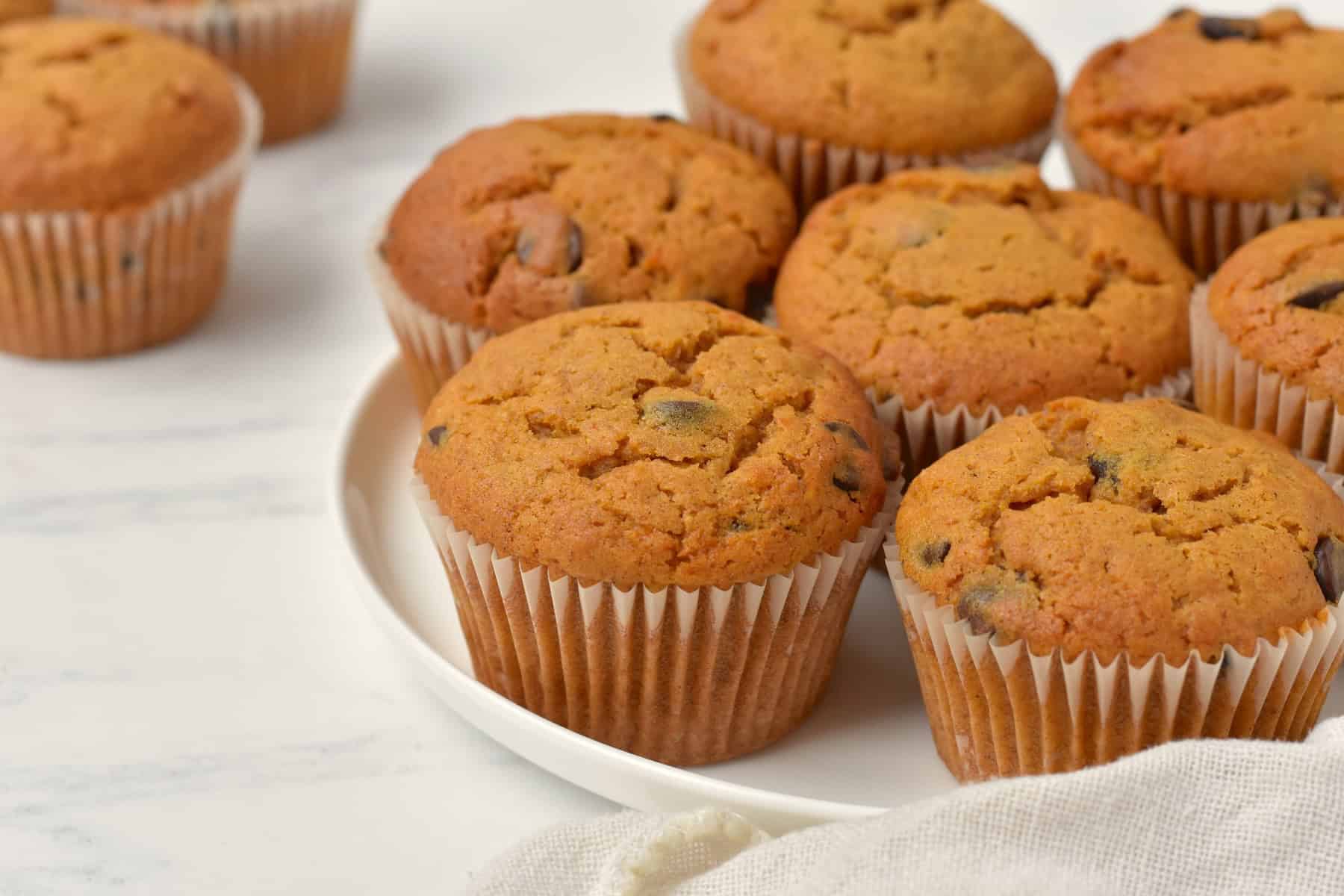 Chocolate chip pumpkin muffins on cooling rack.