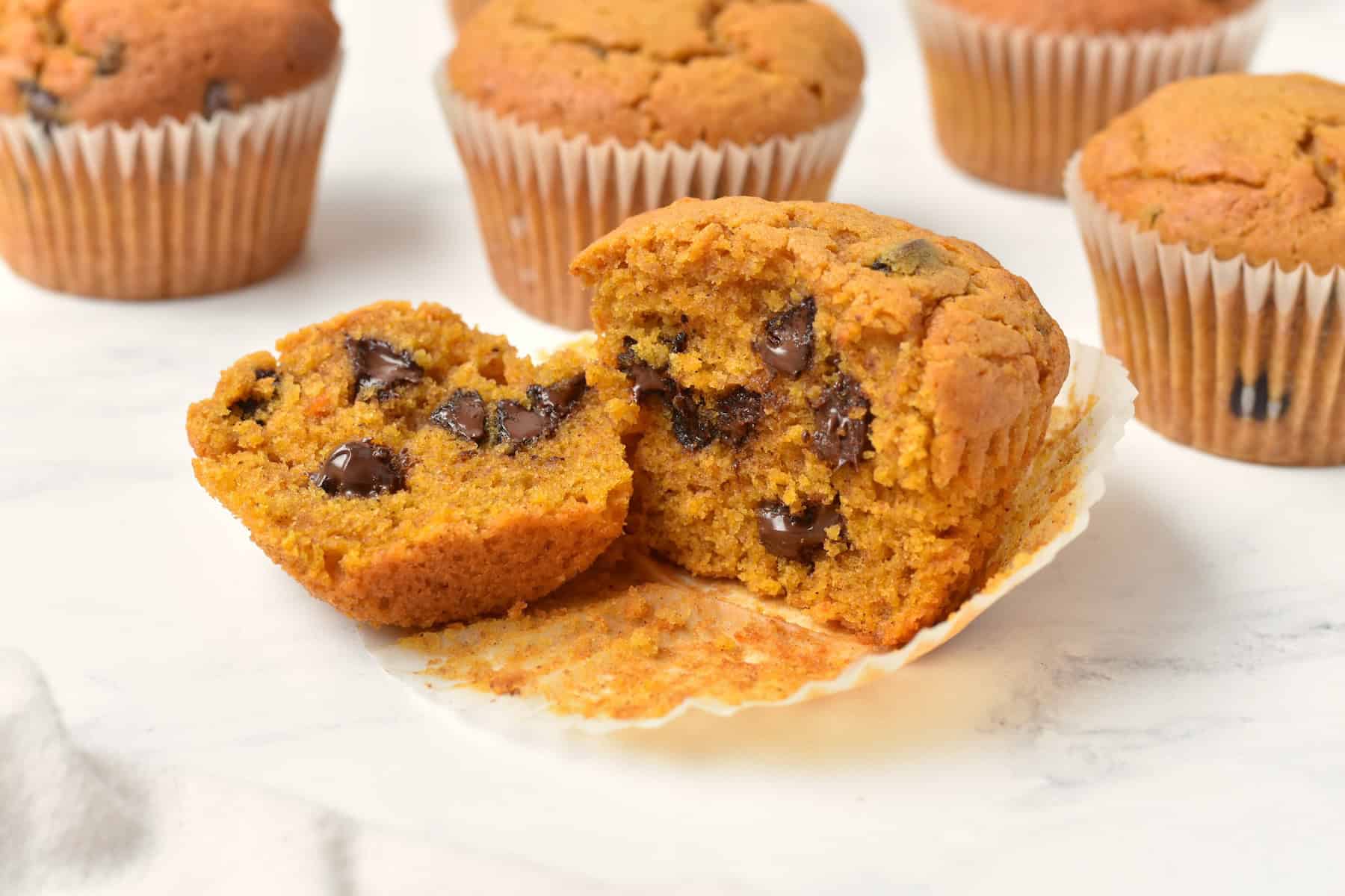 Chocolate chip pumpkin muffin cut in half.
