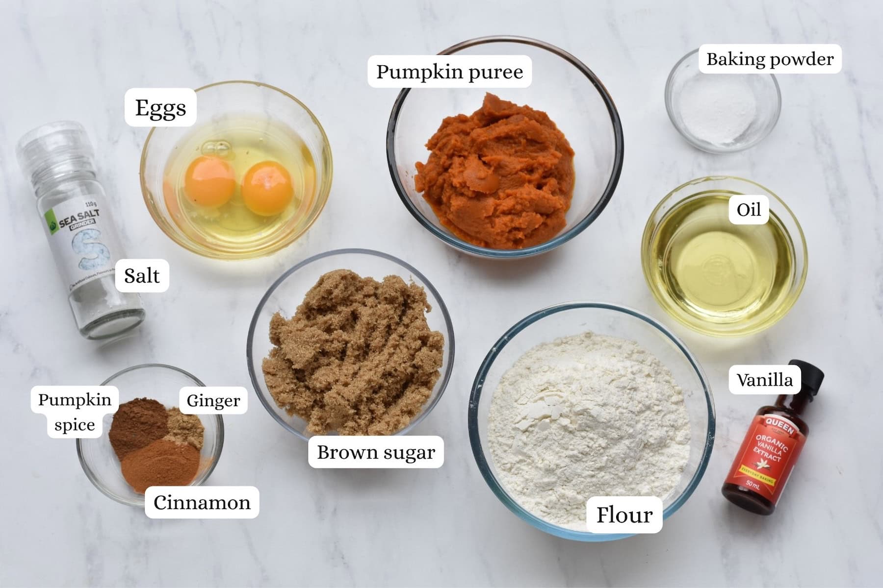 Ingredients in pumpkin muffins laid out on bench and photographed from above.