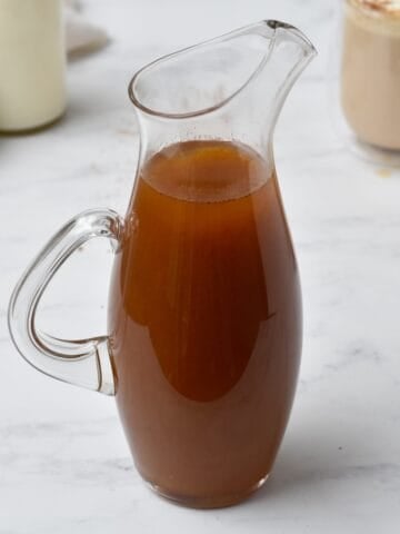 Pumpkin spice syrup in pouring jug.