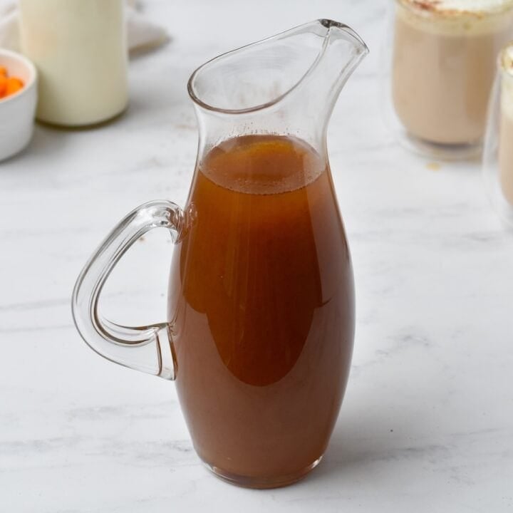 Pumpkin spice syrup in pouring jug.