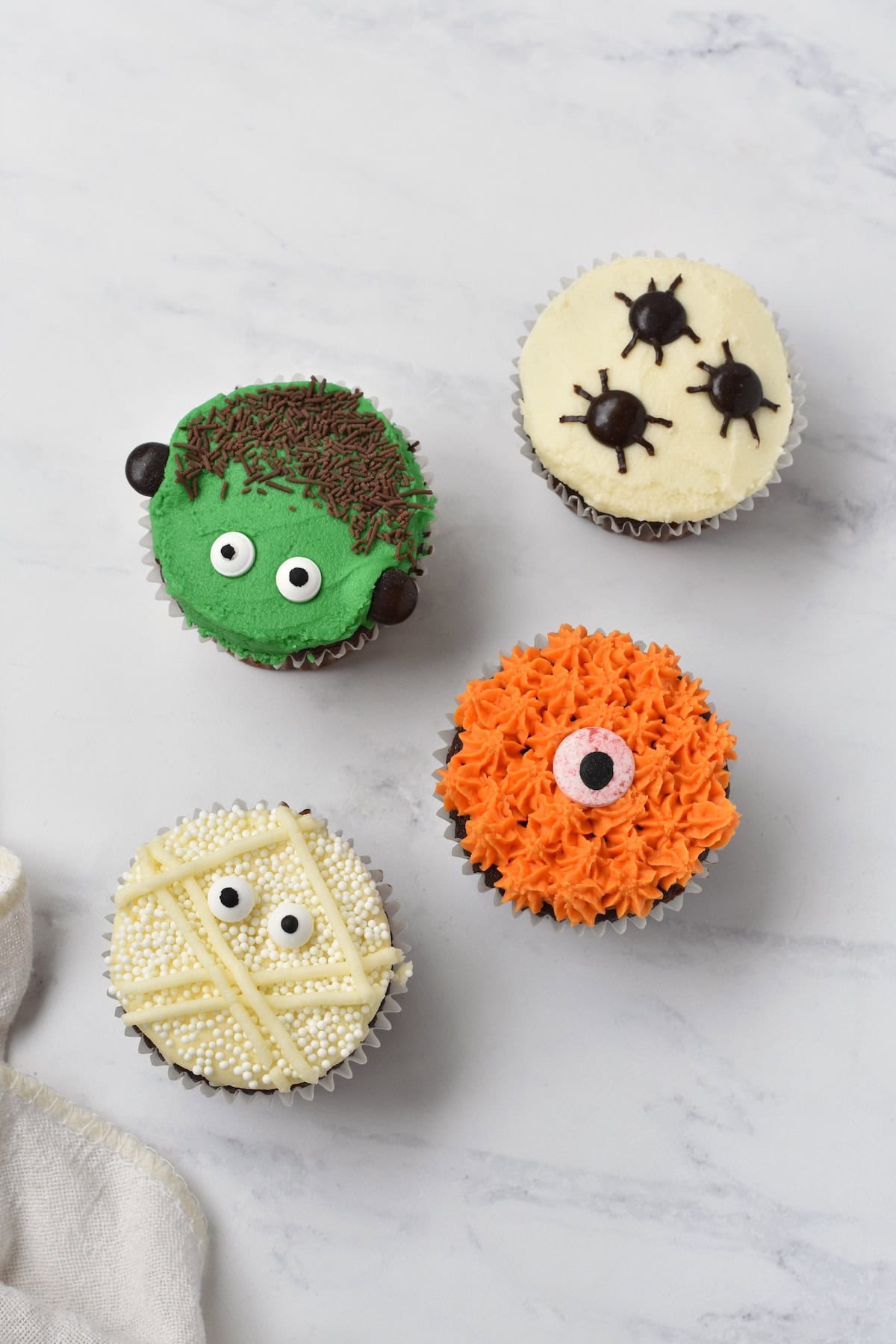 Halloween cupcakes on bench.