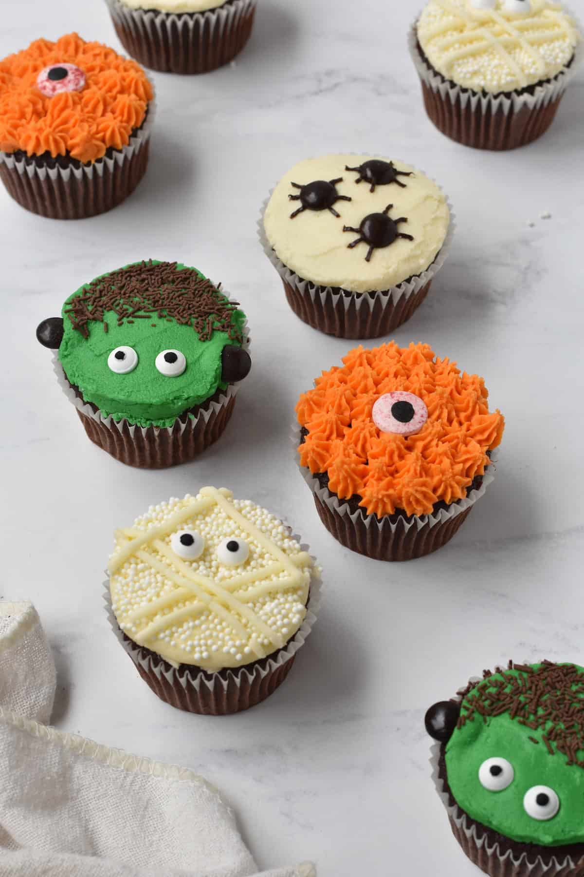 Halloween cupcakes on bench.