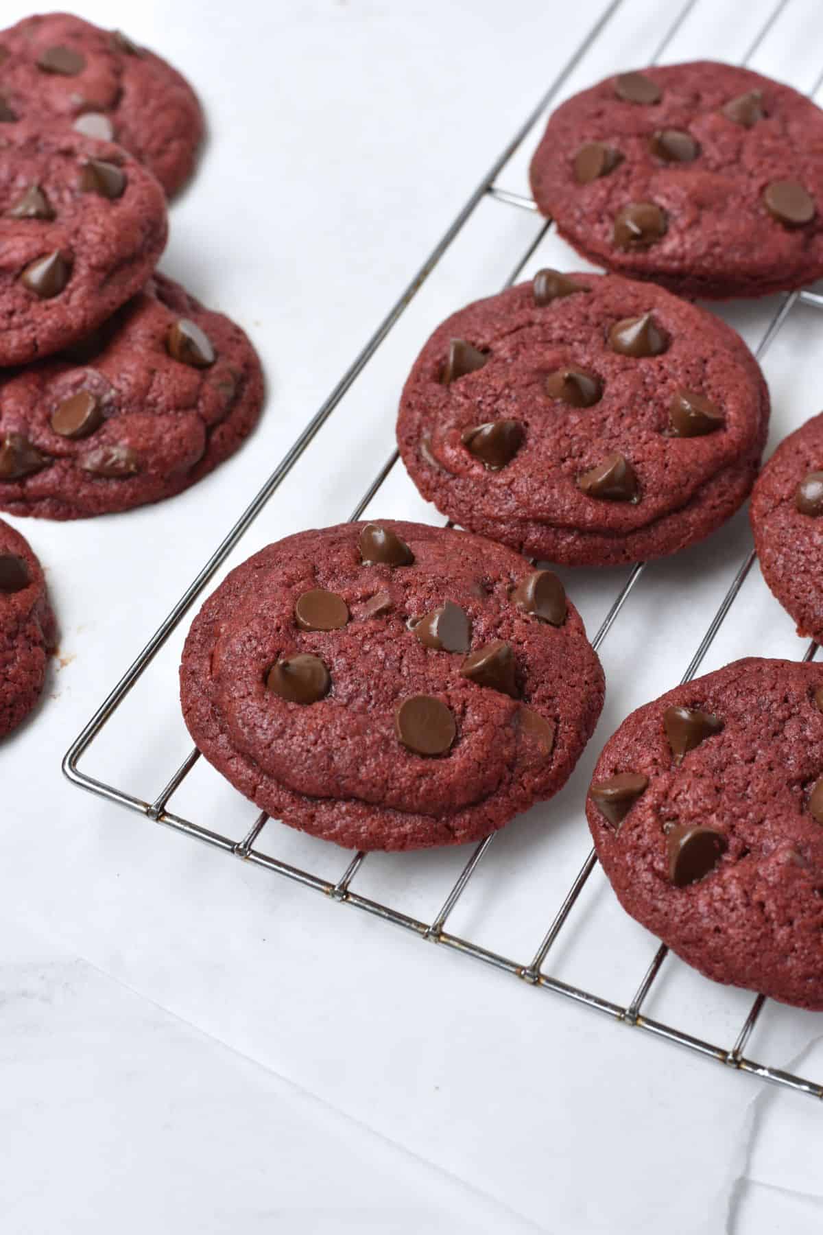Red velvet cookies on a cooling rack.