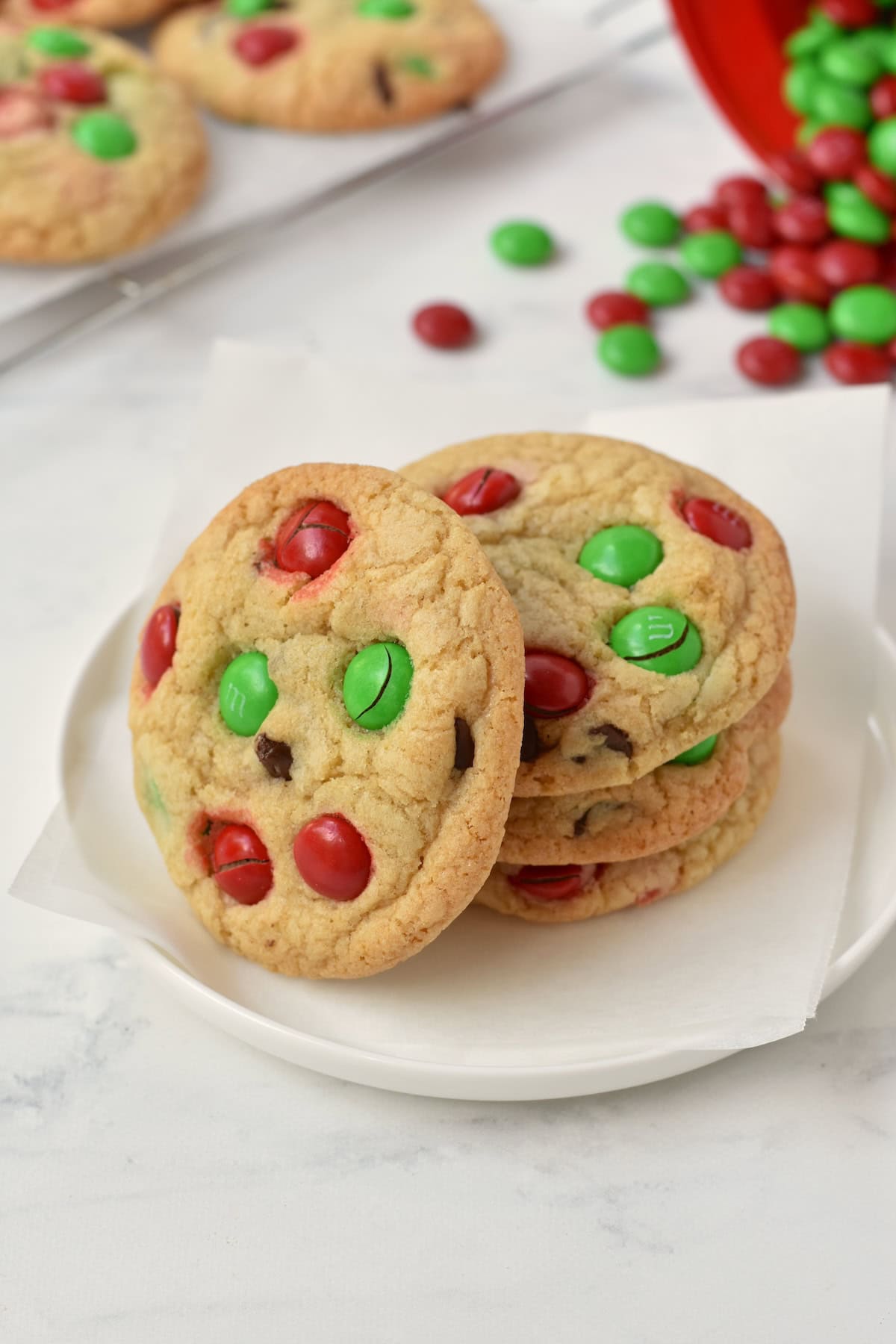Stack of M&M Christmas Cookies on a plate.