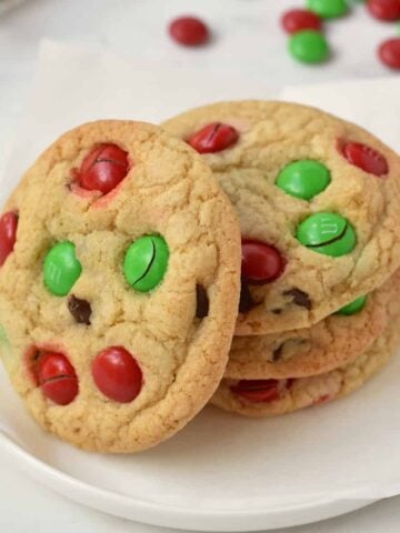 Stack of M&M Christmas Cookies on a plate.