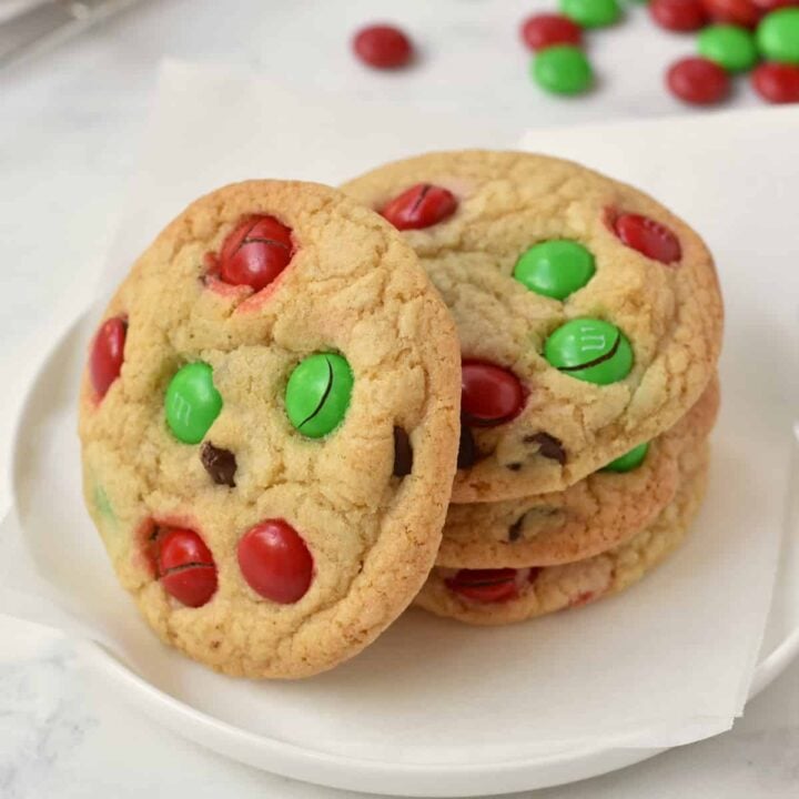 Stack of M&M Christmas Cookies on a plate.